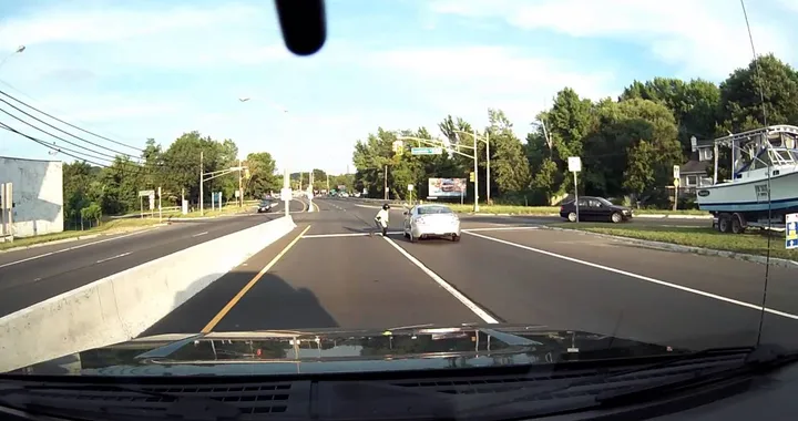 Motorcyclist gets hit by car