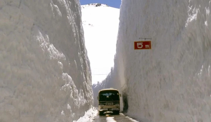 La strada in mezzo a due muraglie di neve alte come grattacieli