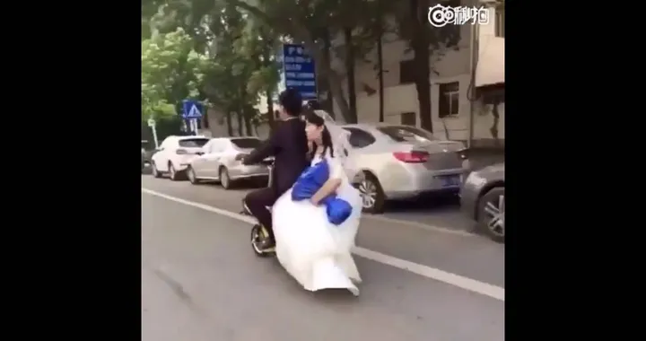 Fail: Bride falls hard off of the back of groom's scooter